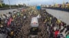 A trailer carrying the coffins containing the bodies of Hezbollah's former leader Hassan Nasrallah and his cousin and successor Hashem Safieddine enters the Sports City Stadium during a funeral procession in Beirut, Feb. 23, 2025.