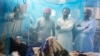 Family members stand next to a patient suffering from dengue fever, in an isolation ward at a local hospital in Rawalpindi, Pakistan, Oct 21, 2014. 
