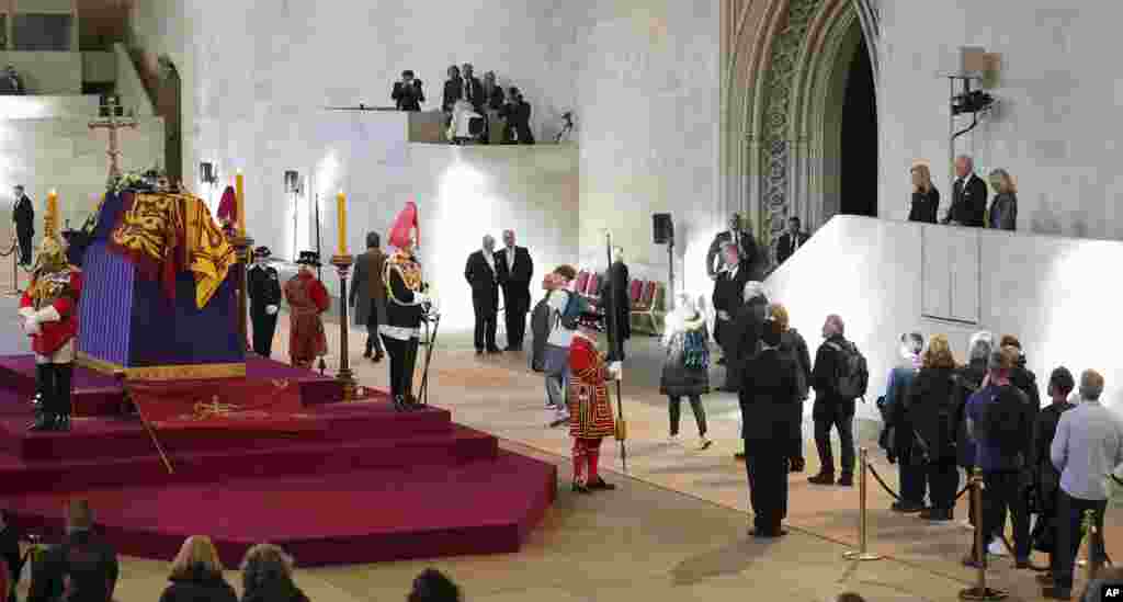 U.S. President Joe Biden and First Lady Jill Biden, far right, view the coffin of Queen Elizabeth II lying in state on the catafalque in Westminster Hall in London.