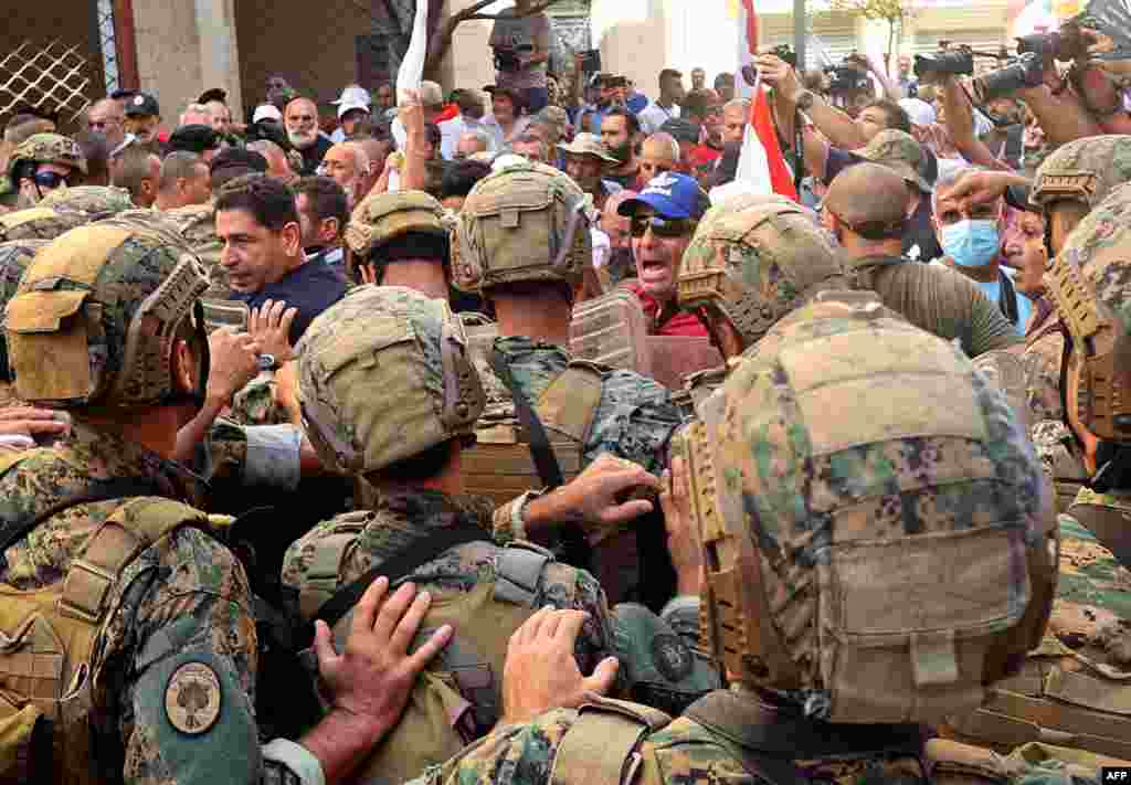 Lebanese army soldiers clash with retired military personnel as they try to break into the parliament in Beirut, during a session to approve the 2022 budget. The protesters were demanding an increase in their monthly retirement pay, decimated during the economic meltdown.