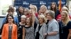FILE - Rep. Martha McSally, R-Ariz., third from left, laughs as she gets her arm raised by former Arizona Republican Gov. Jan Brewer, third from right, as they pose for a photograph with members of the Women's Coalition after a news conference at a campai