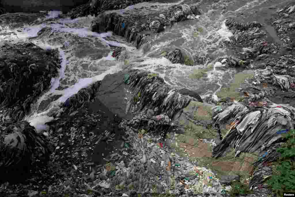 Garbage and plastic bottles float on Las Vacas river considered one of the most polluted rivers in the world, in the municipality of Chinautla, in Guatemala City, Guatemala, where the Ocean Cleanup NGO is testing a device to contain the garbage that ends up in the Atlantic Ocean.