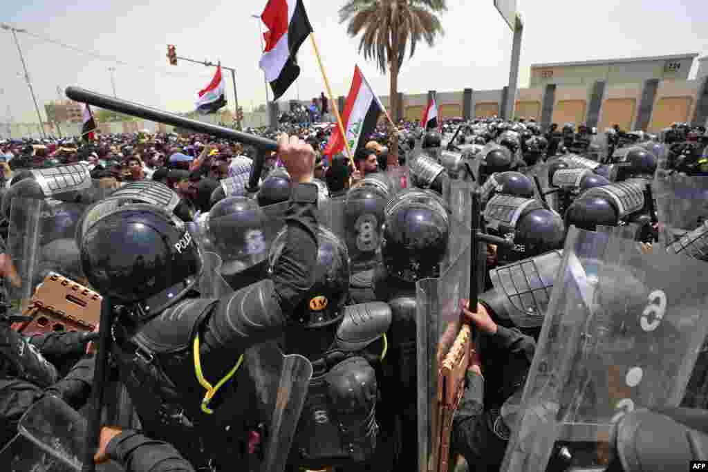 Iraqi security forces deploy to disperse protesters during a demonstration against the government's employment policy near the parliament building in Baghdad's Green Zone.