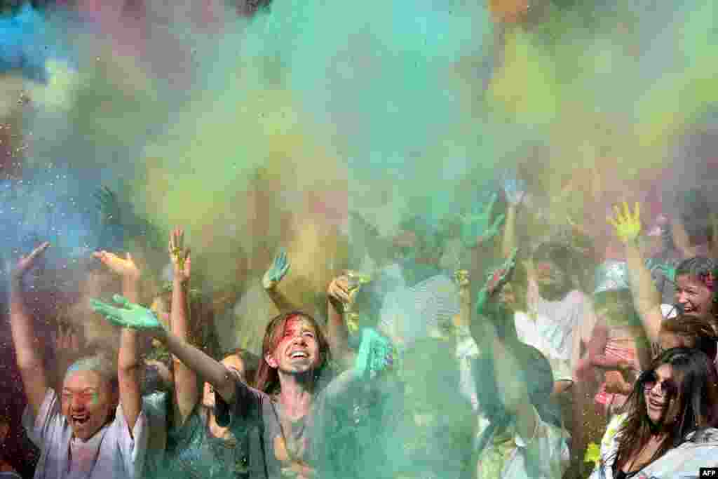 People throw colored powder during the Holi Festival of Colors in Bishkek, Kyrgyzstan.
