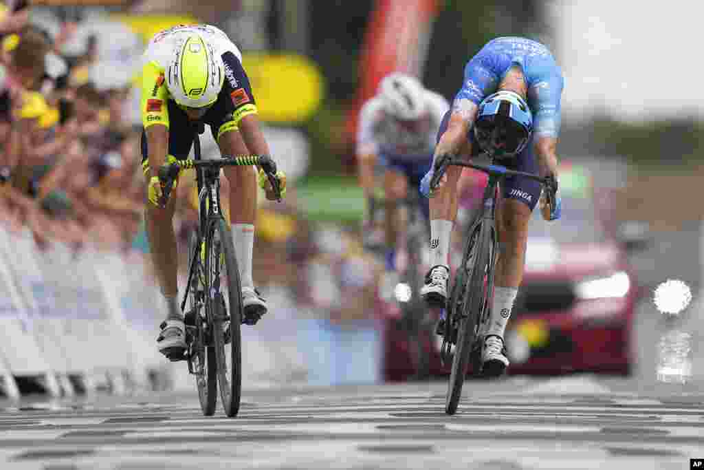 Stage winner Australia's Simon Clarke, right, pushes his wheel over the finish line ahead of Netherlands' Taco van der Hoorn during the fifth stage of the Tour de France cycling race over 157 kilometers (97.6 miles) with start in Lille Metropole and finish in Arenberg Porte du Hainaut, France.