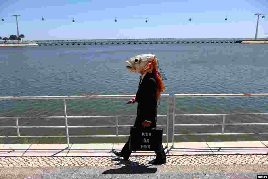 An activist with Ocean Rebellion walks to take part in a protest outside theU.N. Ocean Conference against what they describe as a "war on fish", in Lisbon, Portugal.