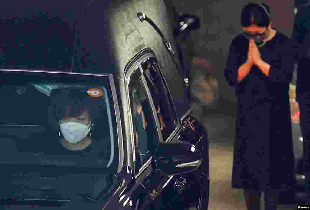 Akie Abe, wife of late former Japanese Prime Minister Shinzo Abe, who was shot while campaigning for a parliamentary election, sits in a vehicle carrying Abe's body to a night vigil at a temple in Tokyo.