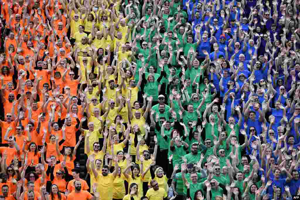 Some 1,000 people wave as they form a human flag on the steps of the Opera House to mark the 44th anniversary of the Sydney Gay and Lesbian Mardi Gras in Sydney.
