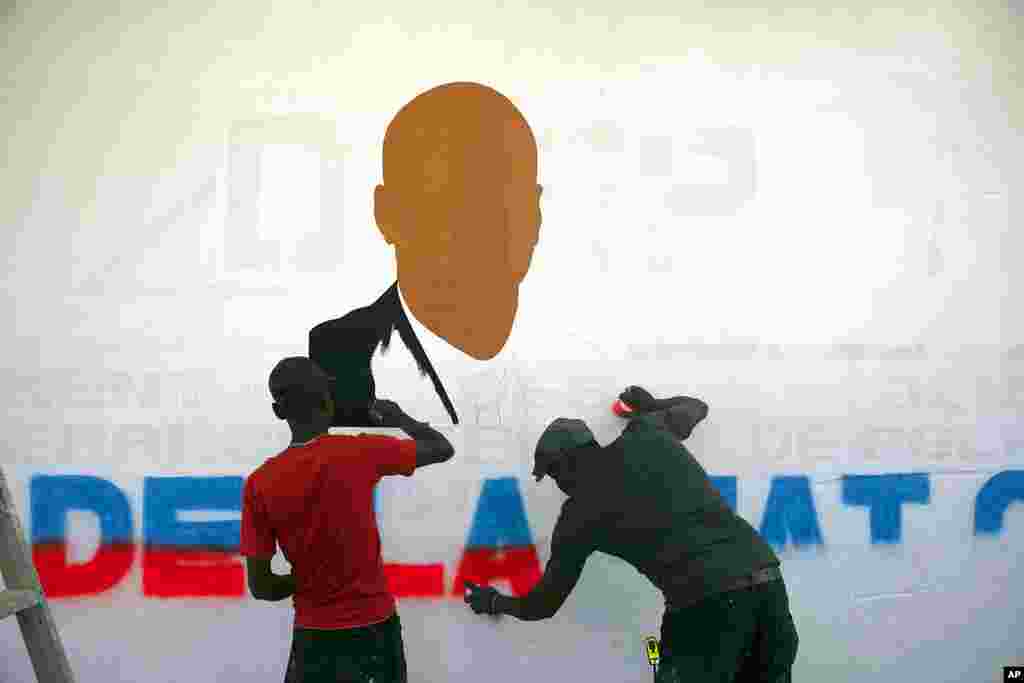 Artists paint a portrait of slain Haitian President Jovenel Moise near the presidencial residence where he was assassinated in the Petion-ville area of Port-au-Prince, Haiti. A year has passed since Moise was assassinated at his private home.