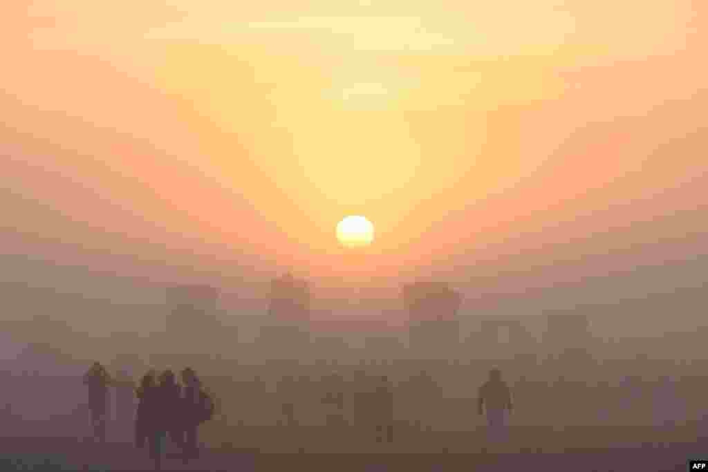 Revelers celebrate the Summer Solstice as the sun rises at Stonehenge, near Amesbury, in Wiltshire, England, in a festival dating back thousands of years to mark the longest day of the year when the sun is at its maximum elevation.