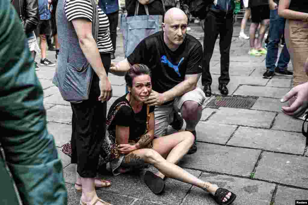 A woman reacts in front of the Field's shopping center, after Danish police said they received reports of a shooting at Field's shopping center, in Copenhagen, Denmark, July 3, 2022.