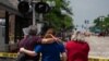 Toddler Found Alone at Parade Shooting; Parents Among the Dead
