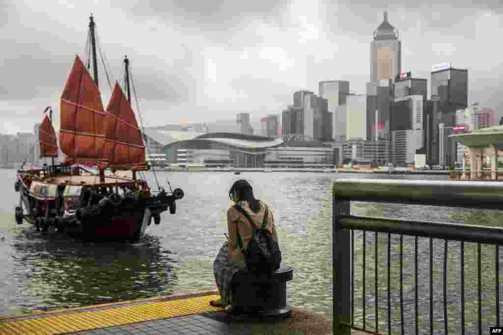 A junk boat sails in to dock in the central district of Hong Kong.