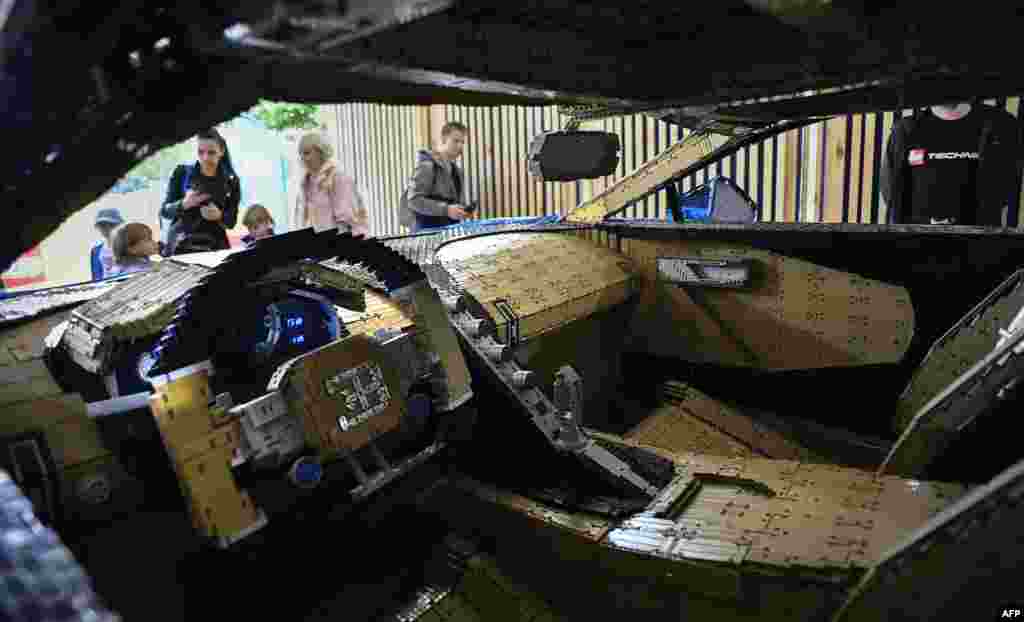 Visitors inspect a driveable full-size Bugatti Chiron car made out of LEGO Technic blocks at an exhibition in Moscow's Gorky Park, Russia.