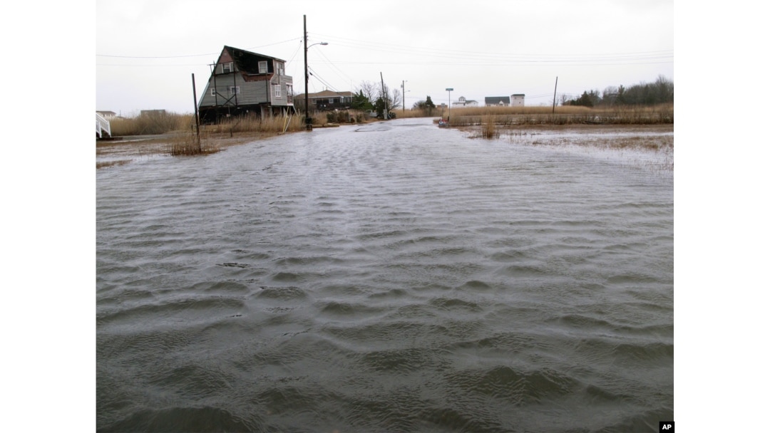 FILE - This March 14, 2017, photo shows the flooded streets of a back bay neighborhood in Manahawkin, N.J., after a moderate storm.