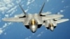 FILE - Two U.S. Air Force F-22 Raptor stealth jet fighters fly near Andersen Air Force Base in this handout photo dated Aug. 4, 2010. 
