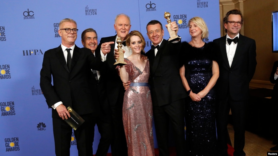 The cast and crew of "The Crown" pose together after winning the Golden Globe award for Best Television Series - Drama as star Claire Foy holds her award for Best Performance by an Actress In A Television Series - Drama, Jan. 8, 2017.