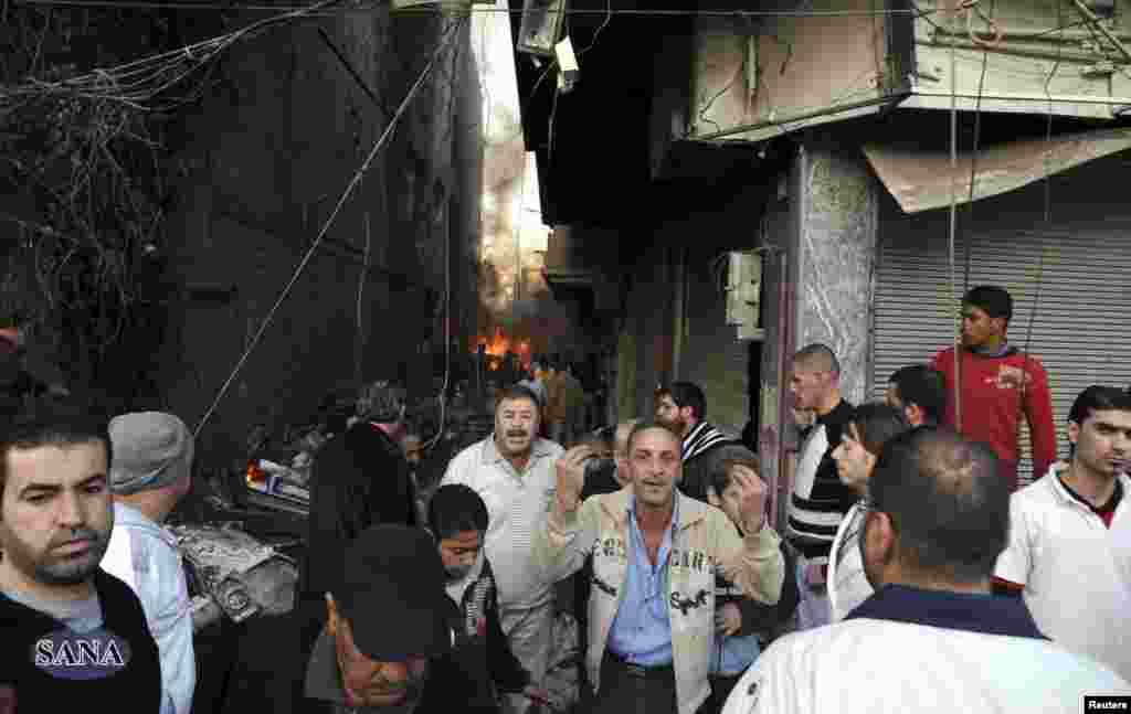 A crowd gathers at the site of a blast in Jaramana district, near Damascus, in this handout photograph released by Syria's national news agency SANA, November 28, 2012.