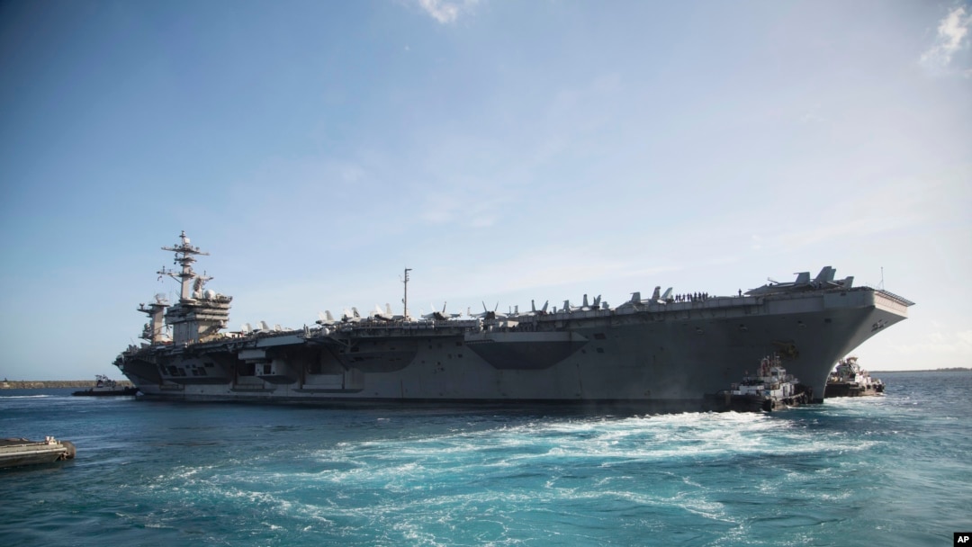 The aircraft carrier USS Theodore Roosevelt (CVN 71) departs Apra Harbor at Naval Base Guam on Thursday, May 21, 2020, following an extended visit to Guam in the midst of the COVID-19 pandemic.