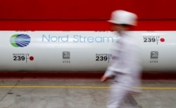 FILE - The logo of the Nord Stream 2 gas pipeline project is seen on a pipe at the Chelyabinsk pipe rolling plant in Chelyabinsk, Russia, February 26, 2020.