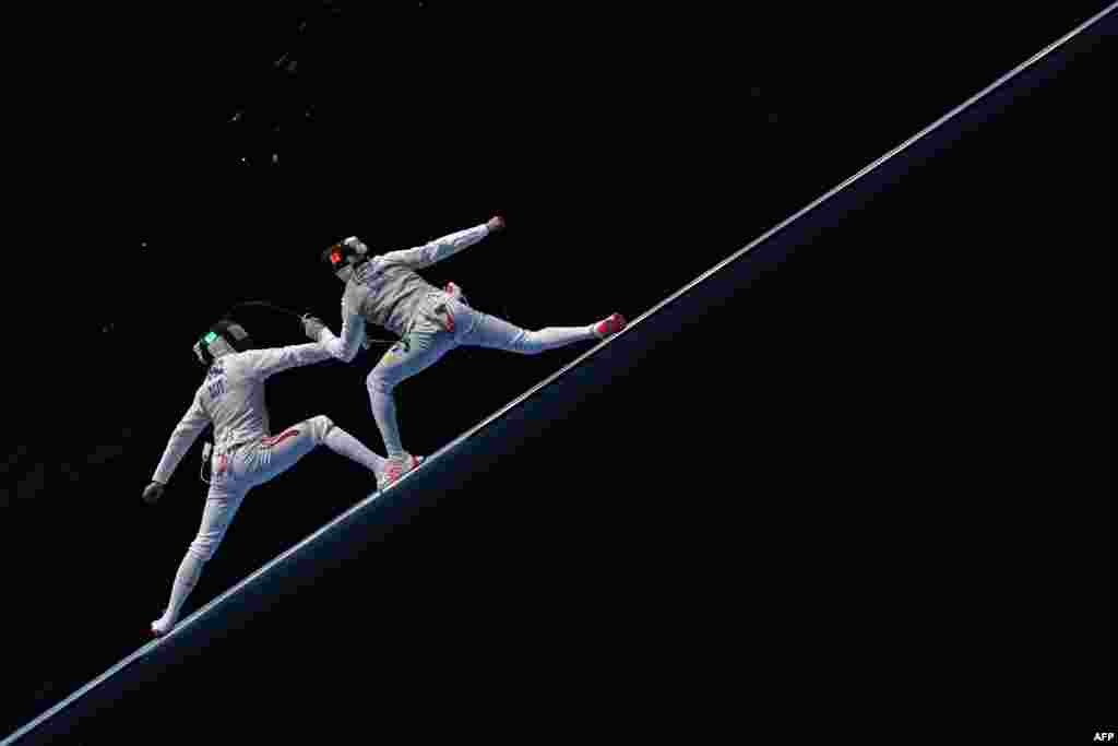 Austria's Rene Pranz (L) competes against Brazil's Guilherme Toldo during their men’s individual foil qualifying bout as part of the fencing event of the Rio 2016 Olympic Games at the Carioca Arena 3, in Rio de Janeiro, Brazil.