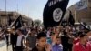 Demonstrators chant pro-al-Qaida-inspired Islamic State of Iraq and the Levant (ISIL) as they carry al-Qaida flags in front of the provincial government headquarters in Mosul, 225 miles (360 kilometers) northwest of Baghdad, Iraq, June 16, 2014.