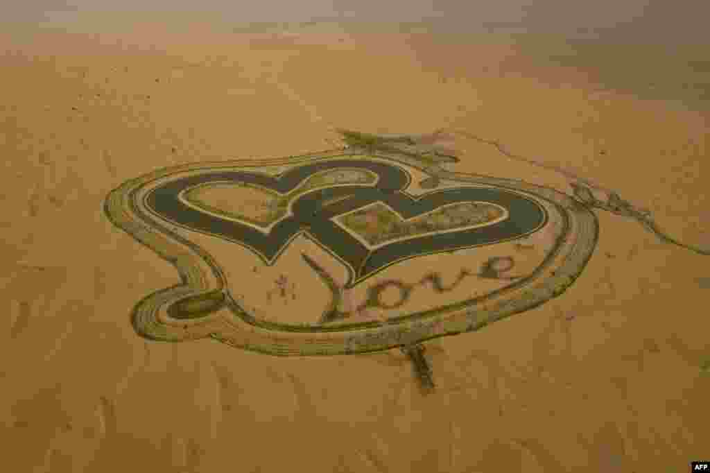 A picture taken with a drone shows the new man-made "Love lake" at al-Qudra desert in the Gulf emirate of Dubai.