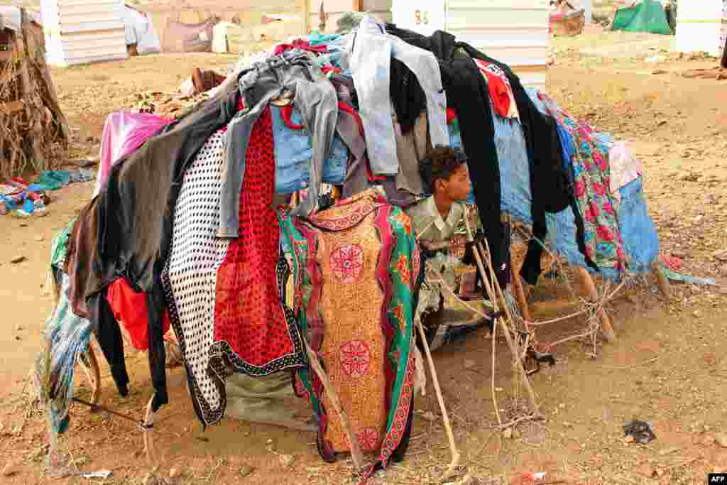 A displaced child who fled the fighting sits at a makeshift camp in the district of Abs, in Yemen's northwestern Hajjah province, June 10, 2019.