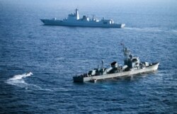 Crew members of China's South Sea Fleet take part in a drill in the Xisha Islands, or the Paracel Islands, in the South China Sea, on May 5, 2016.
