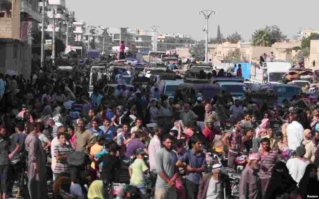 Civilians gather after they were evacuated by the Syria Democratic Forces (SDF) fighters from an Islamic State-controlled neighborhood of Manbij, in Aleppo Governorate, Syria, Aug. 12, 2016.