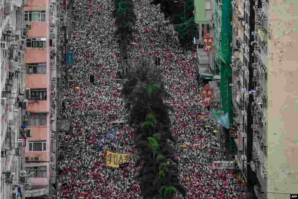 Protesters march during a rally against a controversial extradition law proposal in Hong Kong. Huge protest crowds thronged Hong Kong as anger swells over plans to allow extraditions to China, a proposal that has sparked the biggest public backlash against the city's pro-Beijing leadership in years.