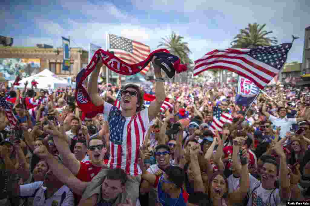 Fans cheer at a viewing party in Hermosa Beach, California, June 16, 2014, after the U.S. scored a second goal during the 2014 Brazil World Cup Group G soccer match between Ghana and the U.S.