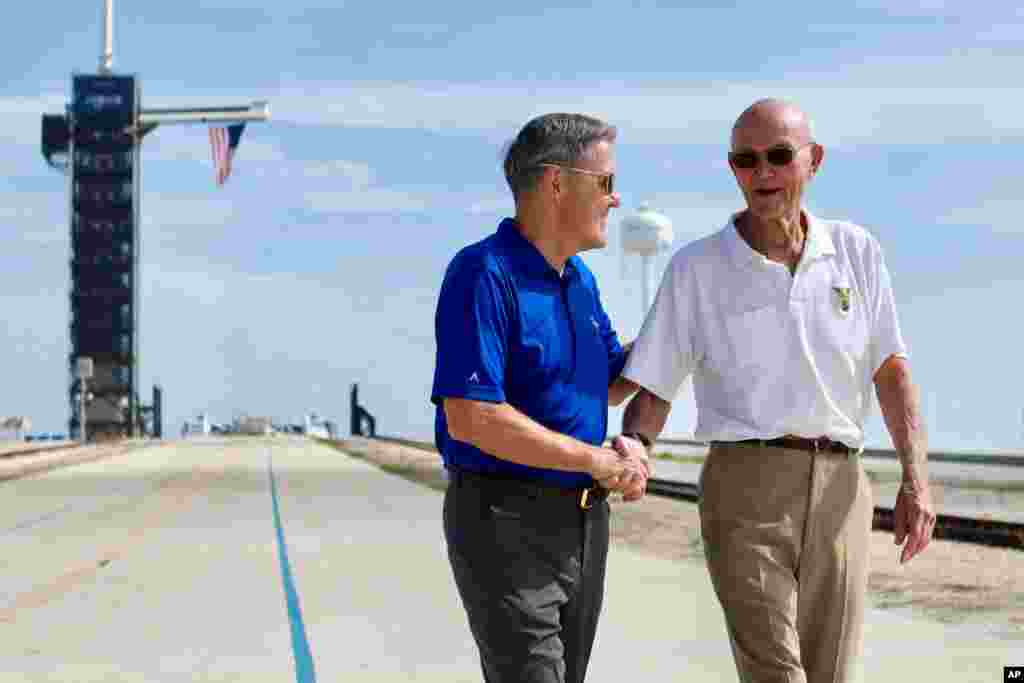 In this photo made available by NASA, astronaut Michael Collins, right, speaks to Kennedy Space Center Director Bob Cabana at Launch Complex 39A, about the moments leading up to launch at 9:32 a.m. on July 16, 1969, and what it was like to be part of the first mission to land on the moon. Collins was orbiting in the Command Module, while Neil Armstrong and Buzz Aldrin went to the surface in the Lunar Module.