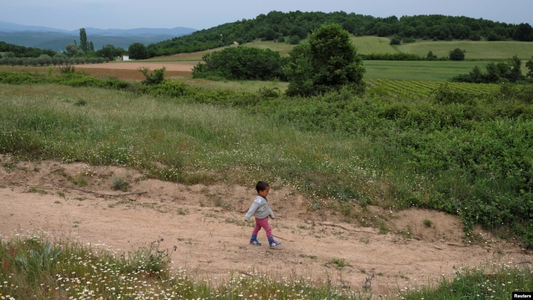 A child who tried to cross the border walks back to a makeshift camp for refugees and migrants at the Greek-Macedonian border near the village of Idomeni, Greece, May 11, 2016.