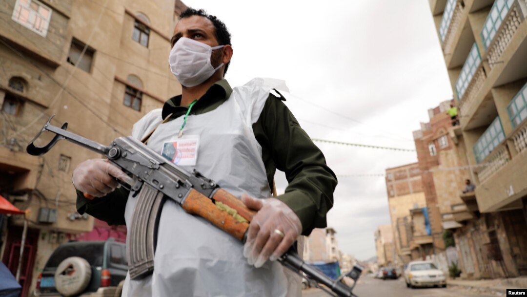 A security man wearing a protective mask stands on a street during a 24-hour curfew amid concerns about the spread of the coronavirus disease (COVID-19), in Sanaa, Yemen May 6, 2020.