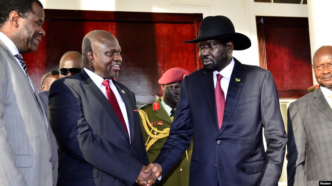 Leader of the Sudan People's Liberation Movement in Opposition (SPLM-IO) Riek Machar shakes hands with South Sudan's President Salva Kiir after a tripartite summit at the State House in Entebbe, Uganda, Nov. 7, 2019.