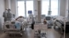 Doctors attend to a patient inside the intensive care unit for people infected with the new coronavirus, at a hospital in Moscow, Russia, May 2, 2020.