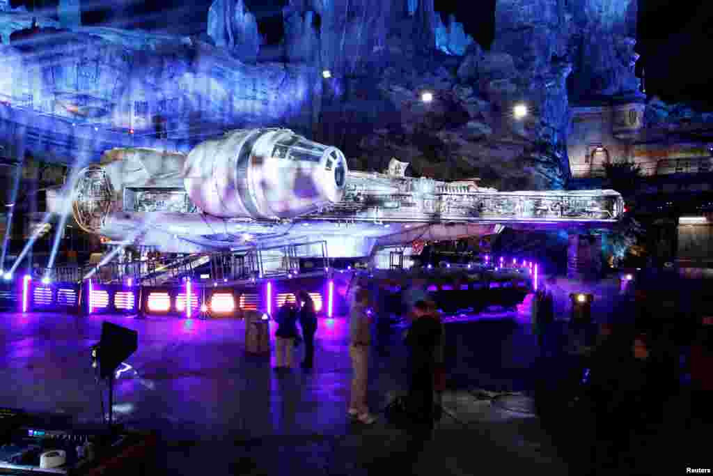 Guests explore "Star Wars: Galaxy's Edge" near a Millennium Falcon starship at Disneyland Park in Anaheim, California, May 29, 2019.
