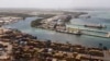 FILE - Cargo containers sit stacked as cranes load and unload containers from cargo ships at the Cristobal port, operated by the Panama Ports Company, in Colon, Panama, Feb. 4, 2025.