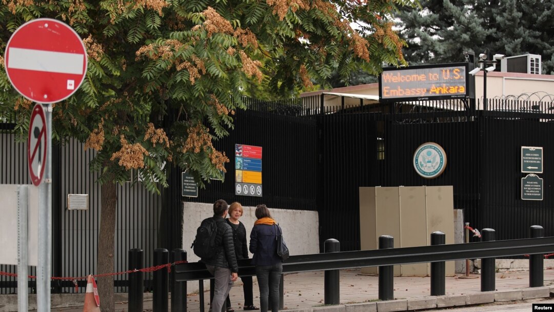 People wait in front of the visa application office entrance of the U.S. Embassy in Ankara, Turkey, Oct. 9, 2017. 