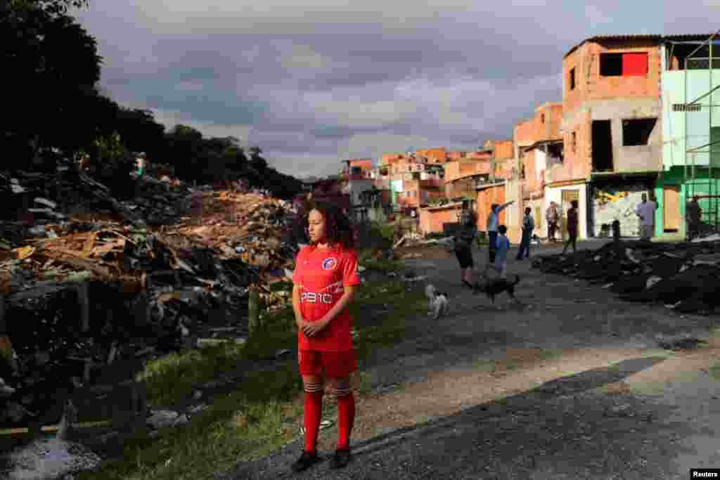 Vitoria Batista Oliveira, 14, waits for a boy to catch a missing ball during a training session of soccer in Jardim Peri Alto slum, on the outskirts of Sao Paulo, Brazil, June 5, 2019.