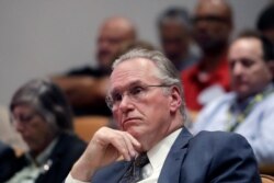Pacific Gas and Electric Company CEO Bill Johnson listens to speakers during a California Public Utilities Commission meeting in San Francisco, Oct. 18, 2019.