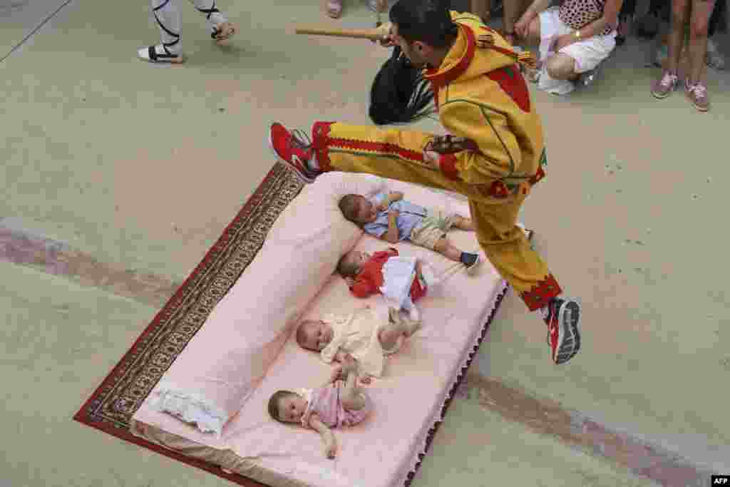 The "Colacho", a character that represents the devil, jumps over babies lying on a mattress in the street during 'El Salto del Colacho' (The Devil's Jump) festival, in the village of Castrillo de Murcia, near Burgos, Spain, June 23, 2019.