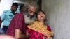 Asha Moni, right, the wife of murdered Bangladeshi blogger Niloy Chakrabarti, weeps outside her home in Dhaka on August 8, 2015. 