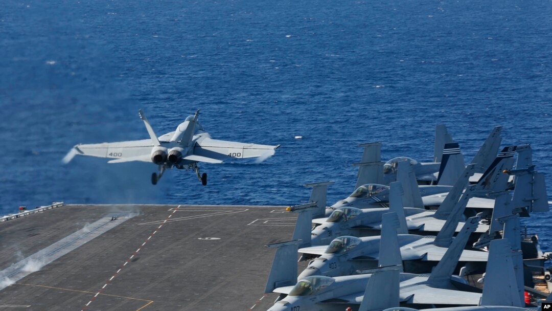 In this May 3, 2019, photo released by the U.S. Navy, An F/A-18E Super Hornet from VFA 25 launches from the flight deck of the Nimitz-class aircraft carrier USS Abraham Lincoln.