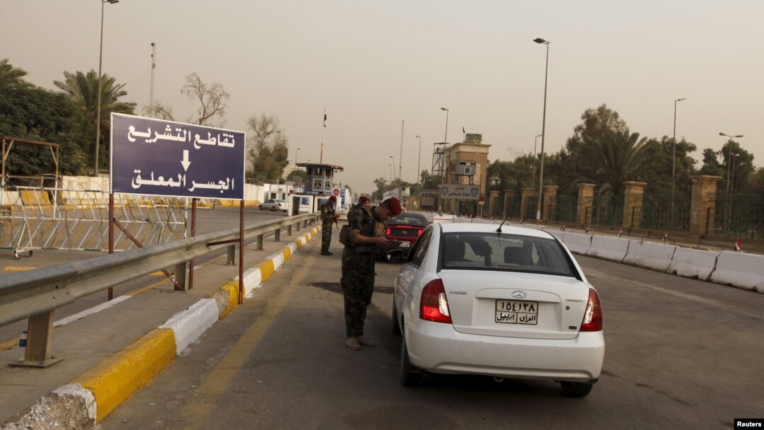 FILE - Iraqi security forces search vehicles at a checkpoint as cars cross into the Green Zone in Baghdad, Iraq, Oct. 5, 2015. The zone houses government buildings and foreign embassies, including that of the United States.