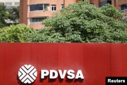 FILE - The corporate logo of the state oil company PDVSA is seen at a gas station in Caracas, Venezuela Nov. 16, 2017.