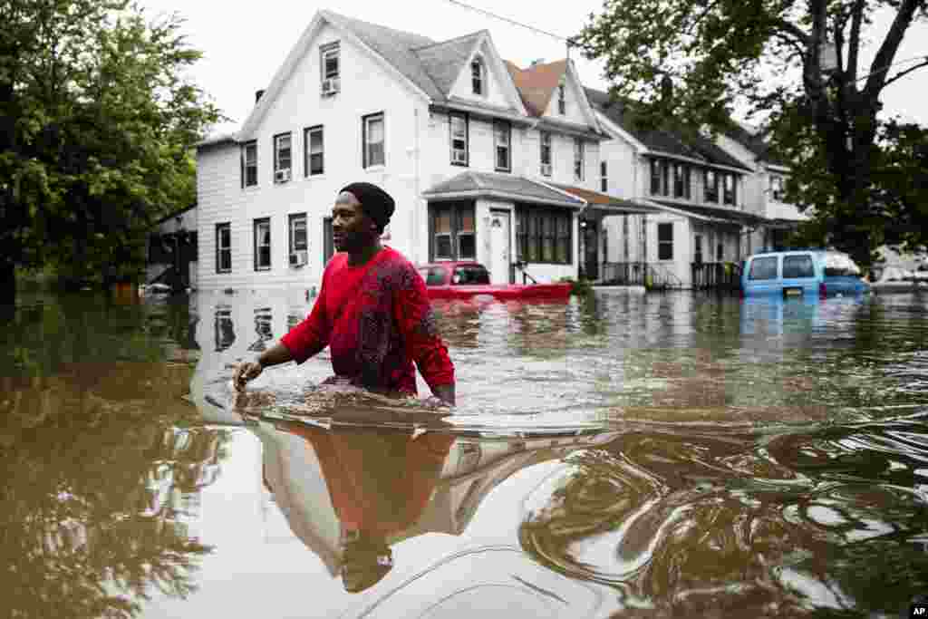 Chris Smith makes his way through floodwaters to the Macedonia Baptist Church in Westville, New Jersey.