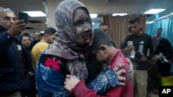 Palestinians wounded in the Israeli bombardment of the Gaza Strip are brought to the hospital in Deir al Balah on Dec. 8, 2023.