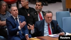 Israel Katz, Foreign Minister to the United Nations points at family members of hostages in the audience during a meeting of the United Nations Security Council on the conflict between Israel and Hamas, at U.N. headquarters in New York, March 11, 2024. 